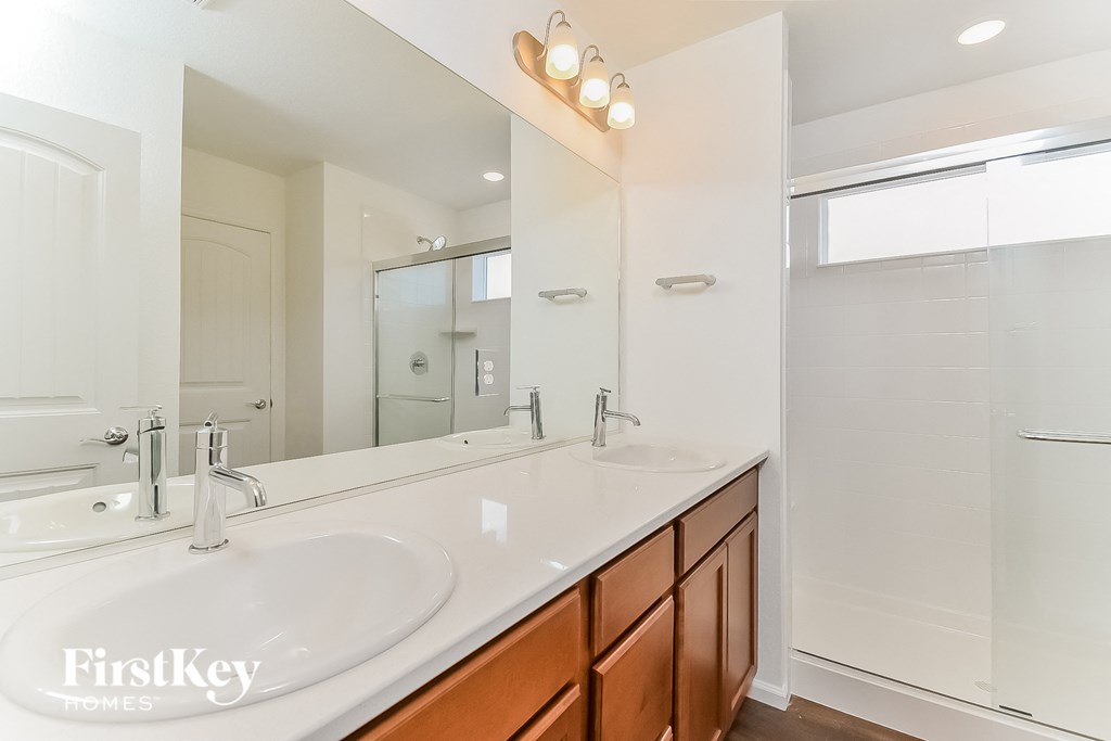 a bathroom with two sinks and a large mirror