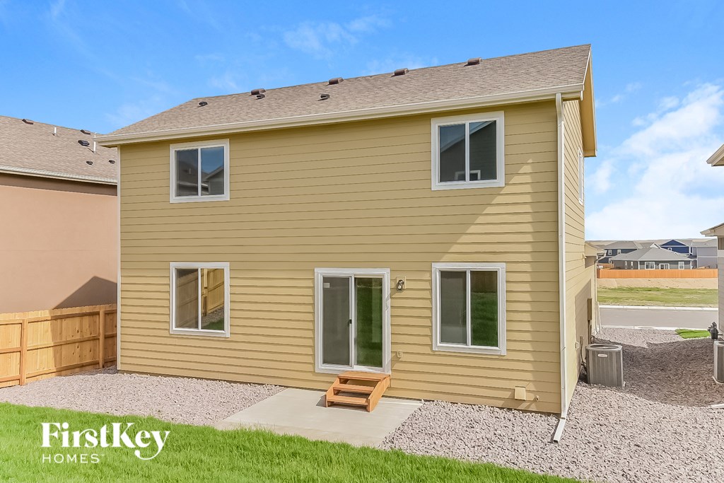 a small house with a wooden bench in front of it
