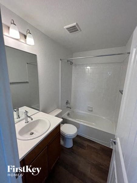 a bathroom with a sink and a toilet and a tub