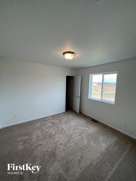 an empty living room with a window and a door