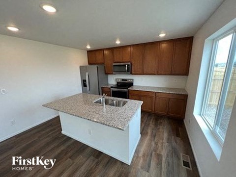 a kitchen with a counter top and a refrigerator