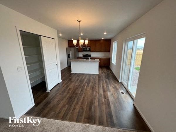 a kitchen and a living room with wood floors