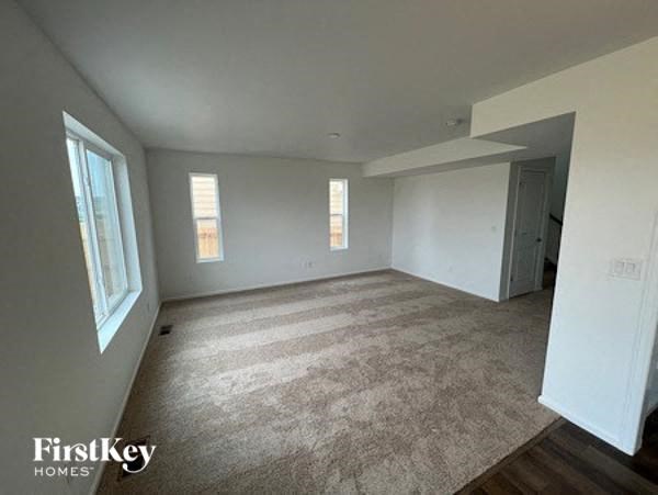 an empty living room with white walls and a door