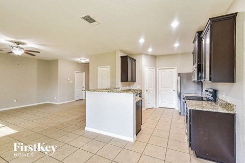 a kitchen with an island and a stove and a sink
