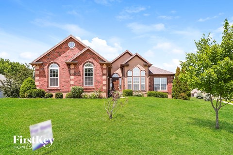 a house on a hill with a green lawn