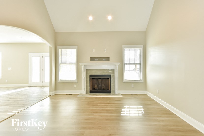 an empty living room with a fireplace