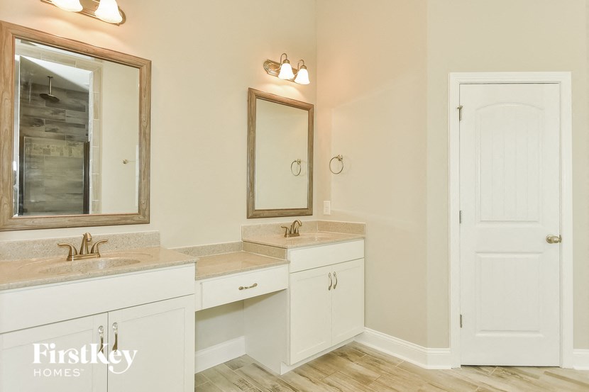 a bathroom with two sinks and a mirror