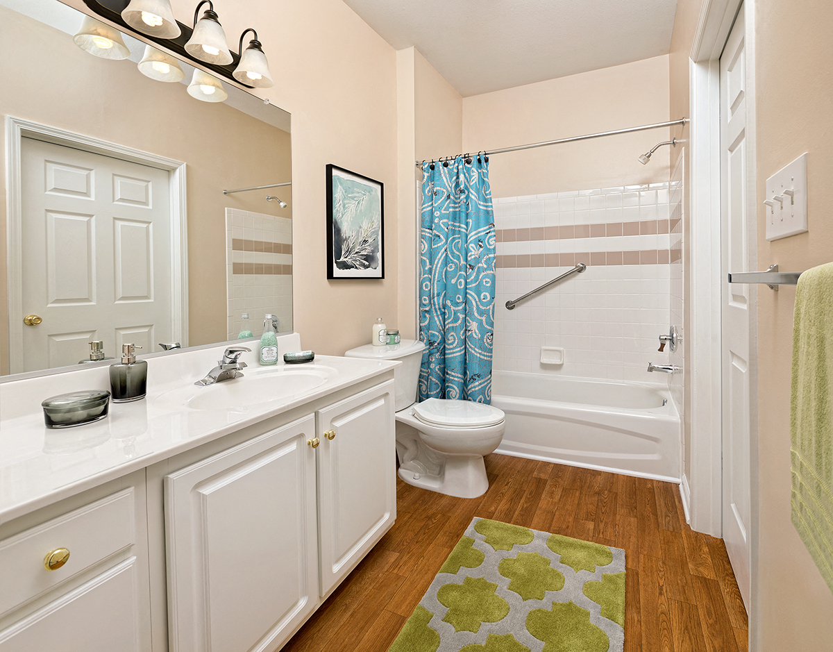 a bathroom with a shower toilet and sink