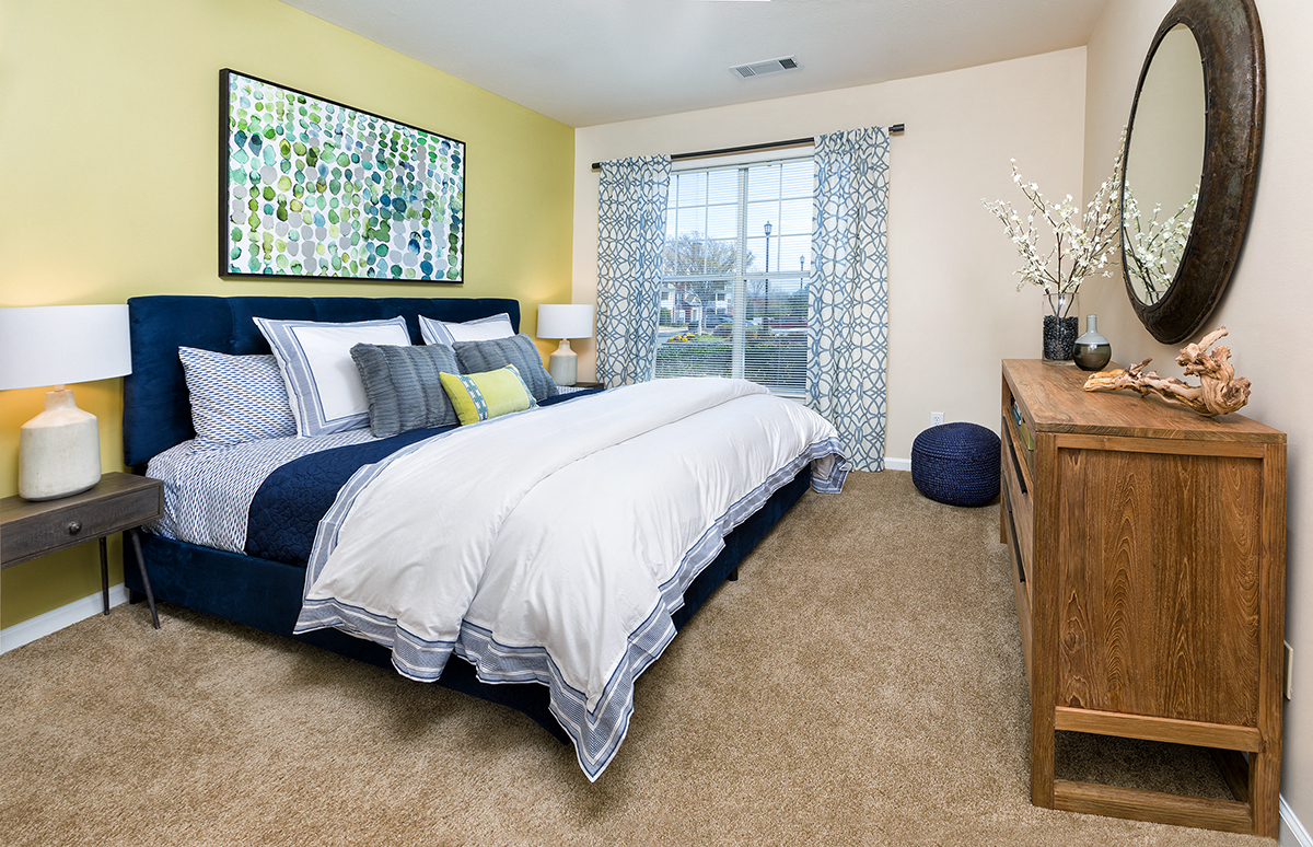 a bedroom with a bed and a dresser