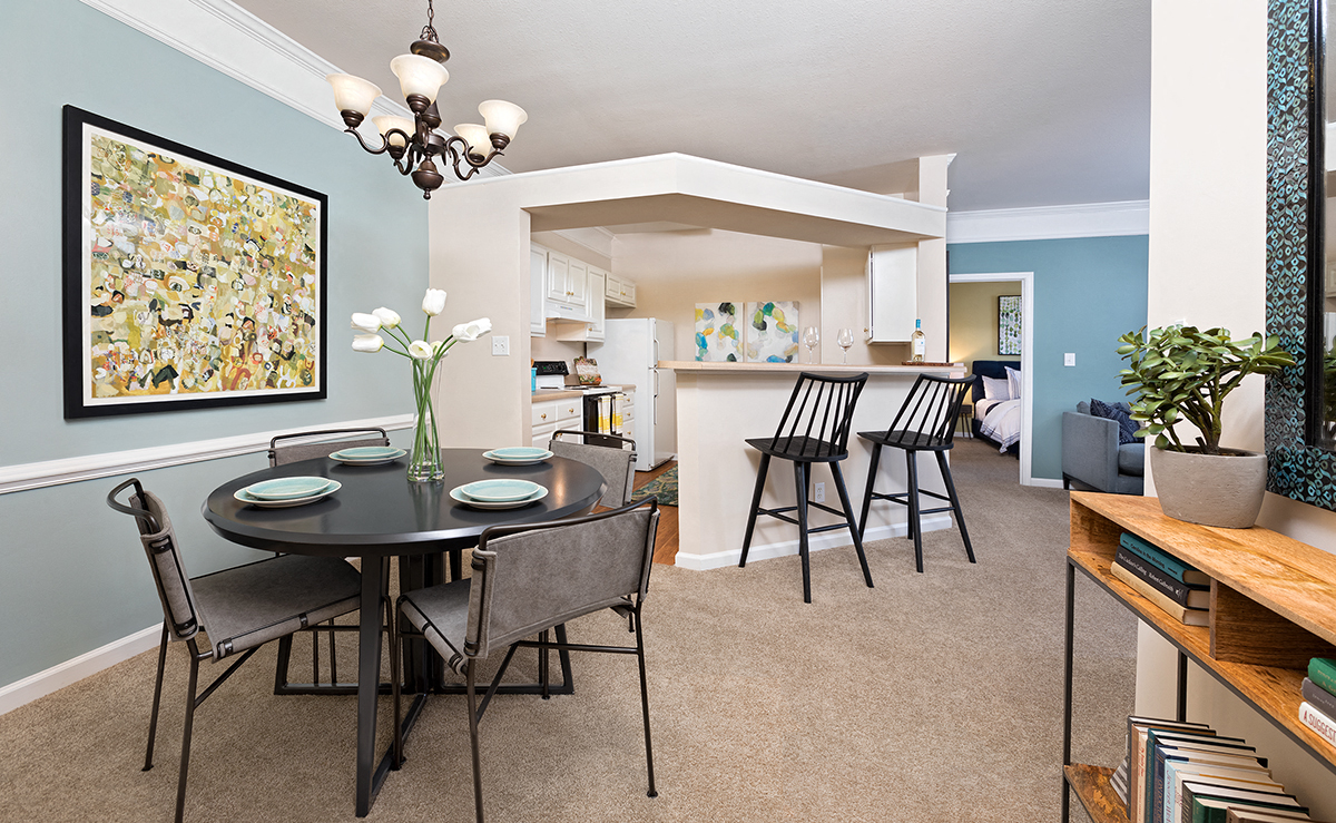 a dining room and kitchen with a table and chairs