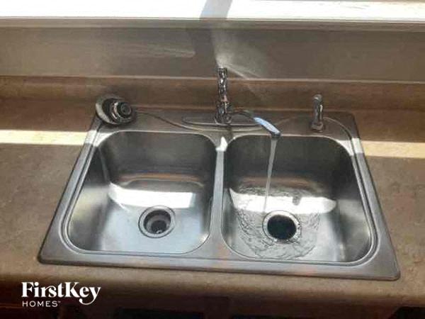 a stainless steel sink with two bowls in it