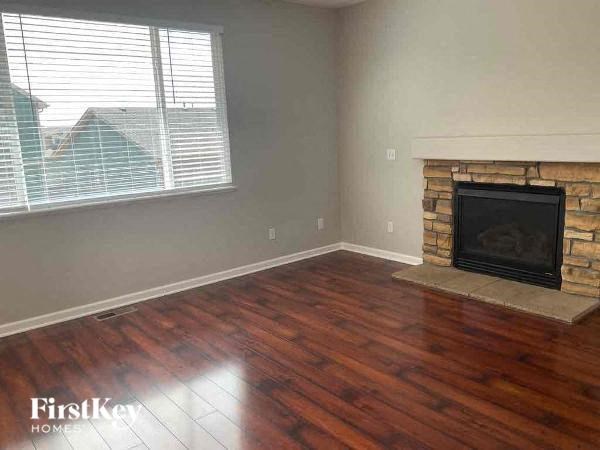 a living room with a fireplace and a wooden floor