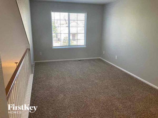 a empty room with a window and a staircase
