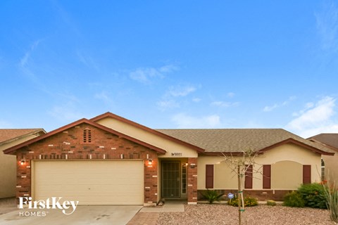 a house with a garage and a blue sky