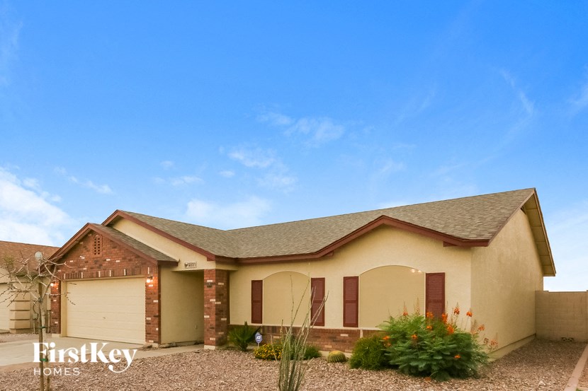 a house with a garage and a blue sky