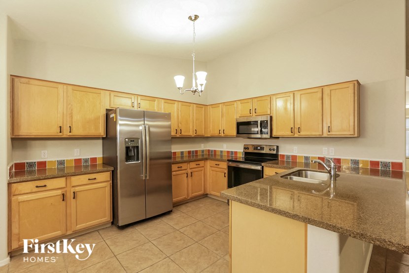a kitchen with stainless steel appliances and wooden cabinets