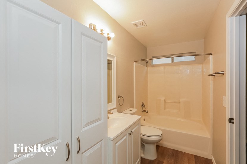 a bathroom with a white toilet and a tub and a sink
