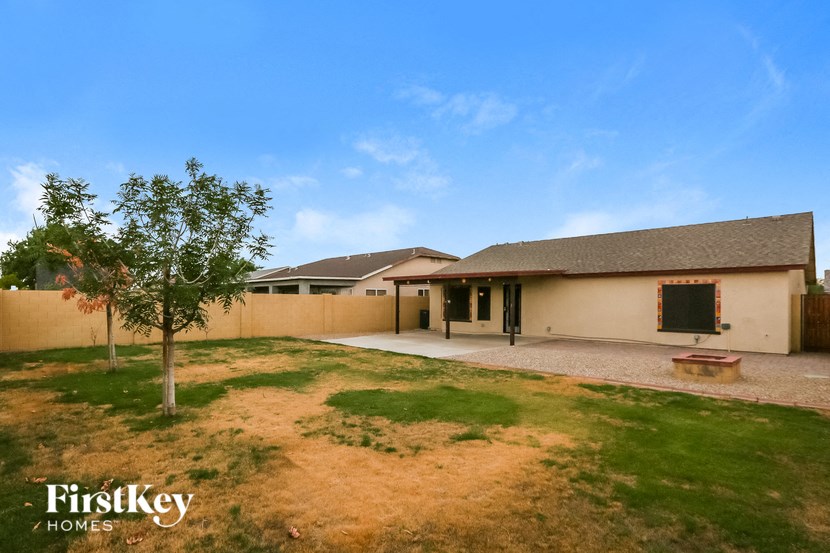 a home with a yard and a house with a patio