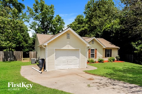a small white house with a white garage door