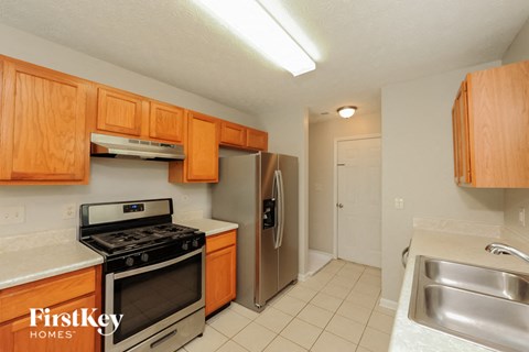 a kitchen with stainless steel appliances and wooden cabinets