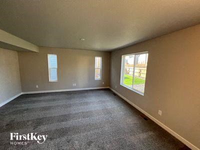 an empty living room with a large window