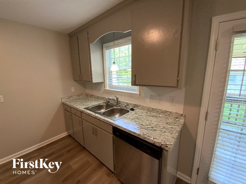 A kitchen with a sink and a window.