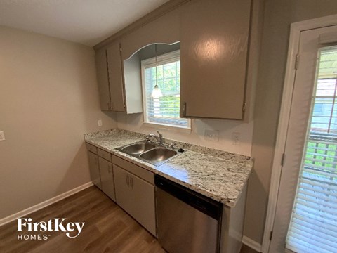 A kitchen with a sink and a window.