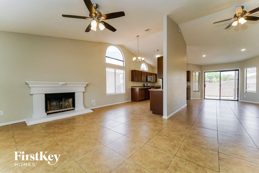 a large living room with a fireplace and tiled floors