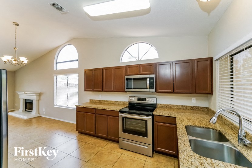 a kitchen with granite counter tops and stainless steel appliances