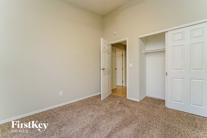 a bedroom with two closets and a door to a hallway