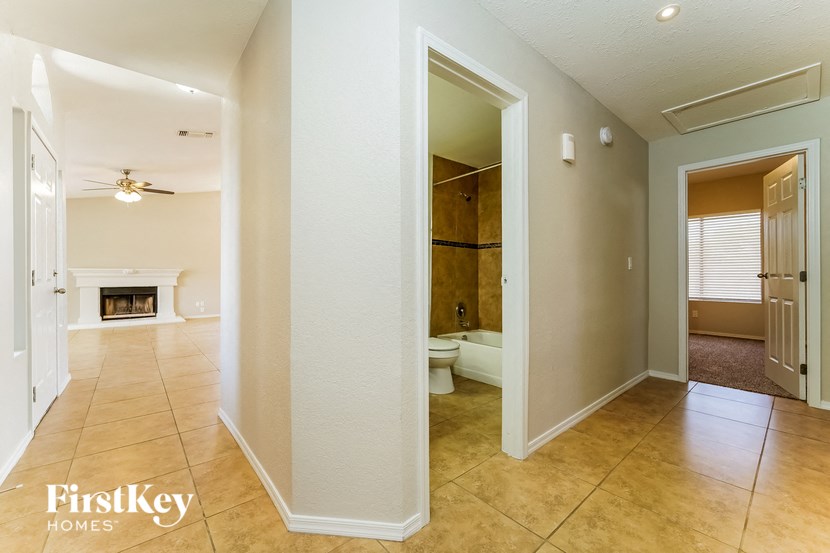 a bathroom and a living room with a toilet and a shower