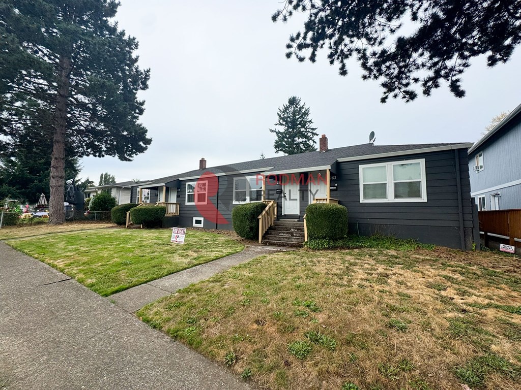 A house with a red stripe on the side is for sale.