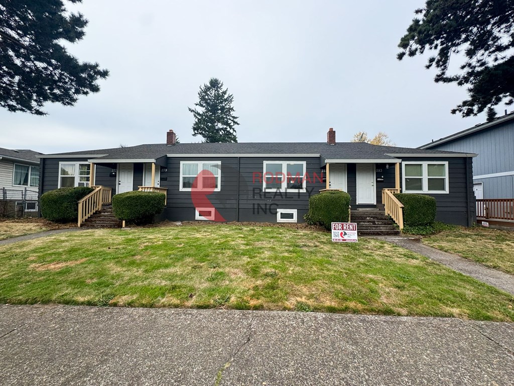 A house with a red and white sign in front of it.
