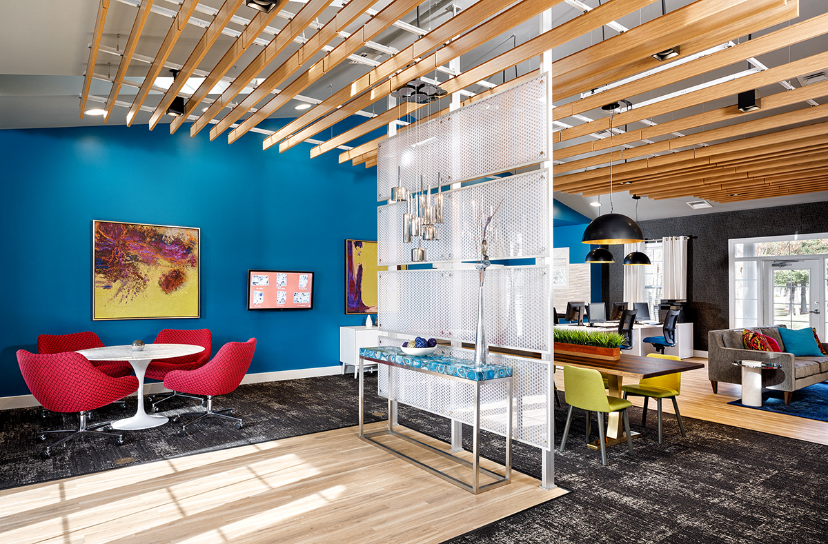 a living room with a blue wall and a table with chairs