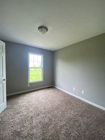 an empty room with blue walls and a window