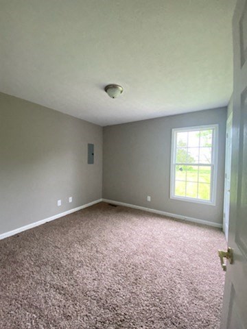an empty room with carpet and a window