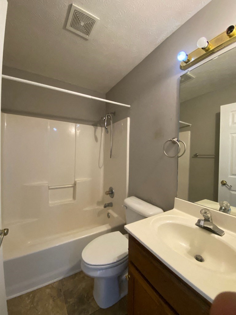 a bathroom with a sink toilet and a shower