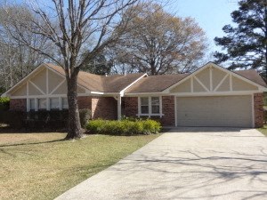 A house with a white garage door and a brown roof.