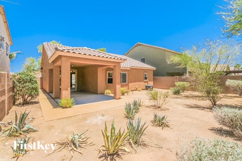 A desert-style home with a pool and a small garden.