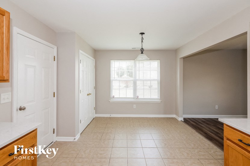 an empty kitchen and dining room with a large window