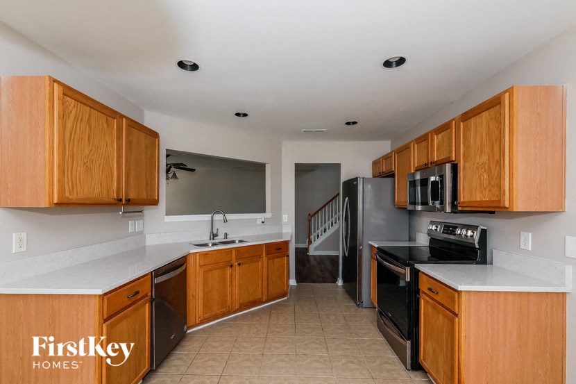 a kitchen with wooden cabinets and black appliances