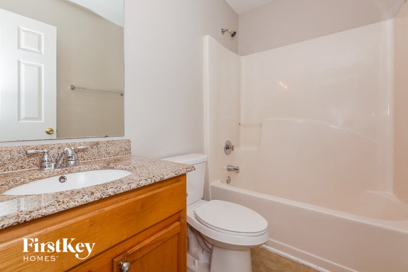 a bathroom with a sink toilet and a bath tub
