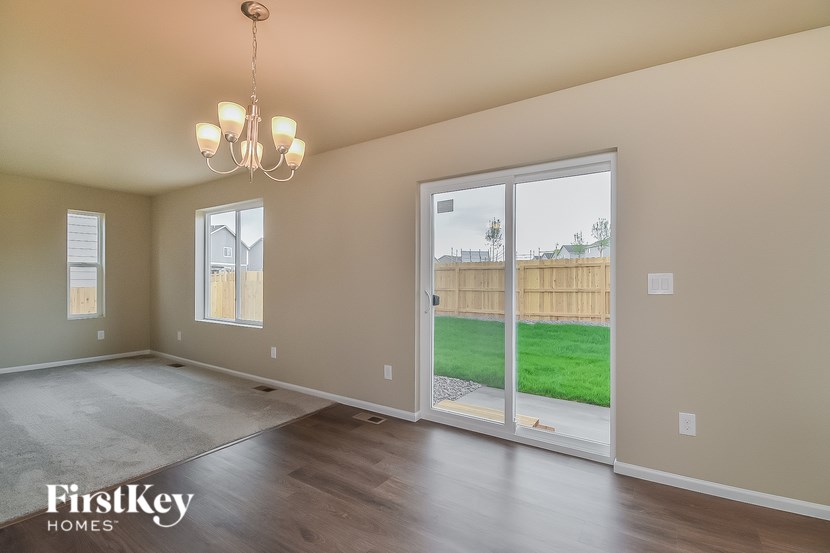 A room with a sliding glass door leading to a backyard.