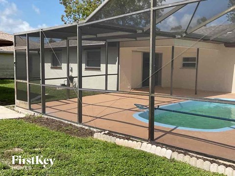 A pool enclosed by a glass wall and a metal frame.