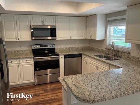 A kitchen with granite countertops and stainless steel appliances.