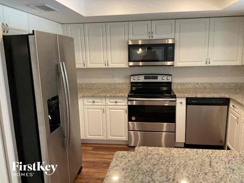 A kitchen with a stainless steel refrigerator and a stainless steel dishwasher.