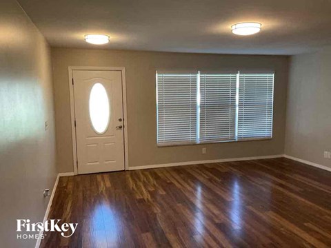 A room with wooden floors and a white door.