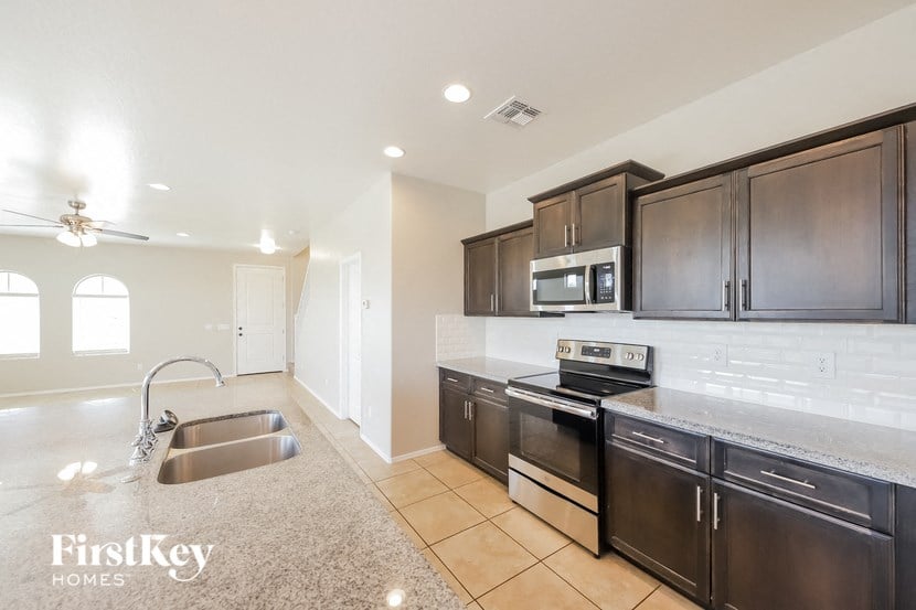 the kitchen is clean and organized with stainless steel appliances and granite countertops
