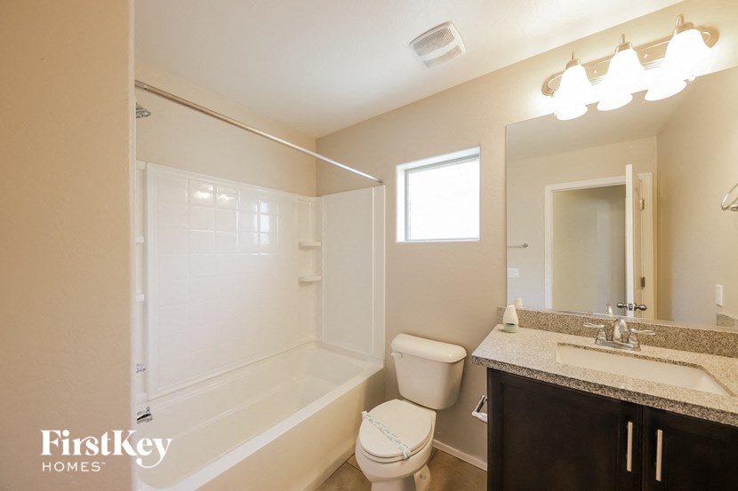 a bathroom with a shower toilet and sink and a mirror