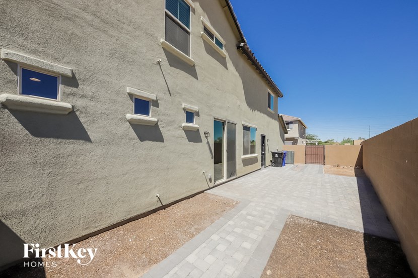 a side view of the side of a building with doors and windows